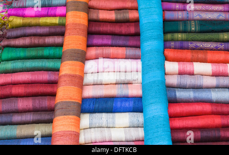 Colourful silk textiles on display at a market stall in Luang Prabang, Laos Stock Photo