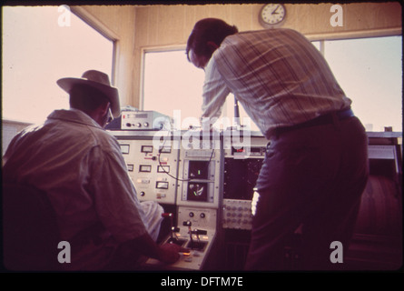 Technicians are seen working at the data control center for the Linear Induction Motor Test Vehicle (LIMTV), a project focused on transportation innovation and advanced engineering technology. Stock Photo