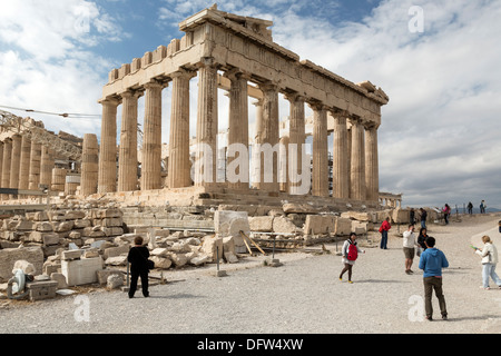 People stand in front of the ancient Temple of Parthenon atop the Acropolis hill in Athens, Greece. Stock Photo
