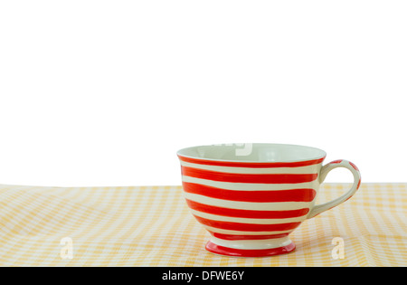 Lovely mug with red line on yellow fabric Stock Photo