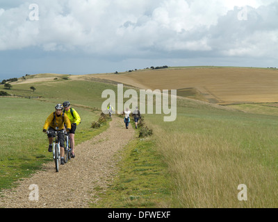 Cyclists and walkers on the South Downs Way between Clayton and Ditchling in West Sussex on a summer day Stock Photo