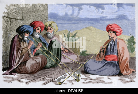 Society. Africa. Tunisia. Tunisian men, c. 1850. Engraving. Later colouration. Stock Photo