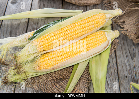 Some fresh Corncobs on vintage background (close-up shot) Stock Photo