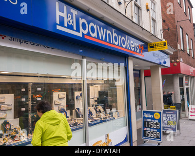 Woman looking in the window of H&T Pawnbrokers in Nottingham at pawned jewelry. Stock Photo