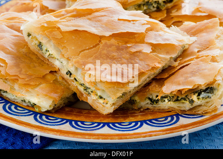 Spanakopita, Greek spinach pie with feta cheese and filo party on on plate Stock Photo