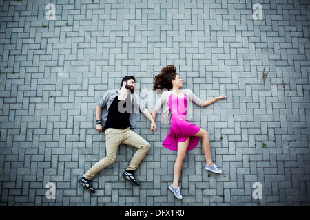Image of affectionate dates lying on pavement Stock Photo