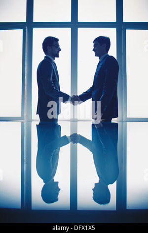 Photo of successful businessmen handshaking after striking deal Stock Photo