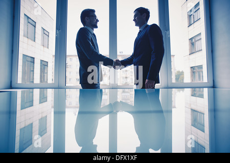 Photo of successful businessmen handshaking after striking deal Stock Photo