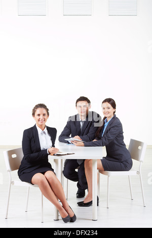 Portrait of smart businesswoman looking at camera on background of working colleagues Stock Photo