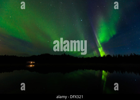 Vivid Northern Lights reflection over Olnes pond in Fairbanks, Alaska Stock Photo