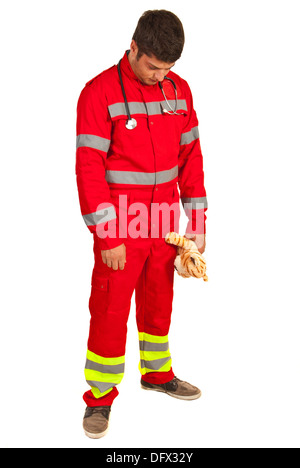 Paramedic disappointed looking down and holding plush toy isolated on white background Stock Photo