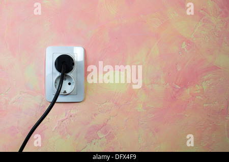 White socket and cable on pink wall. Double socket Stock Photo
