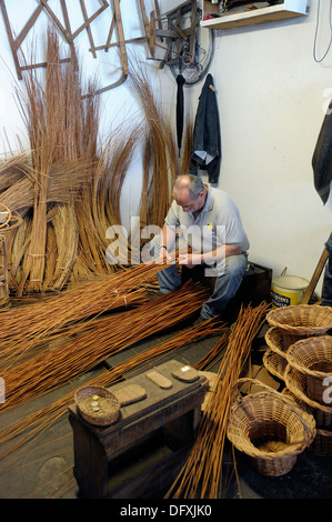 A basket weaver at work in the factory shop in Camacha Madeira Portugal Stock Photo