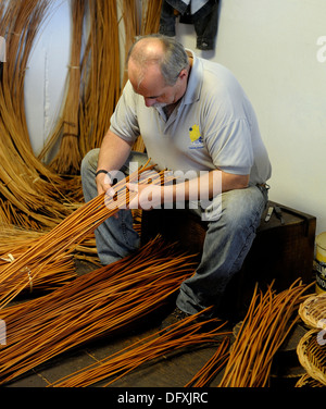 A basket weaver at work in the factory shop in Camacha Madeira Portugal Stock Photo