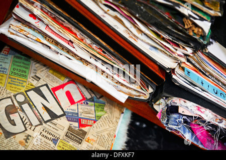 A pile of scrap books, decorated art sketch pads,with text and color,colour, full to bursting Stock Photo