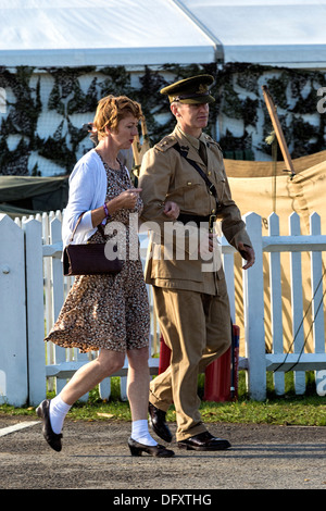 Man in military uniform and woman in retro clothes at the 2013 Goodwood Revival meeting, Sussex, UK. Stock Photo