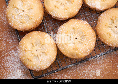 Sweet Christmas mince pies on a Baking tray and wooden board. Stock Photo