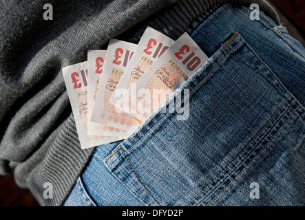 Close up of English money cash banknotes banknote £10 ten pound pounds notes in jeans back pocket England UK United Kingdom GB Great Britain Stock Photo