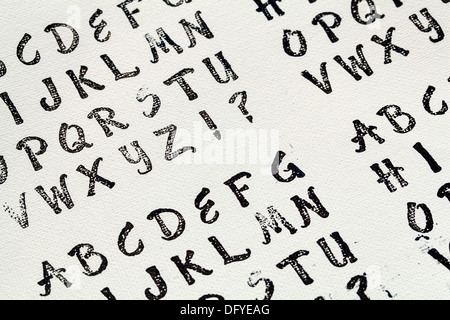 rubber stamp alphabet abstract printed in black ink on white artist canvas Stock Photo