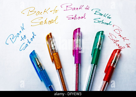Colored pens set on a piece of paper with the inscription BACK TO SCHOOL in many colors. Stock Photo