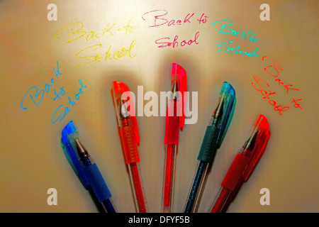 Colored pens set on a piece of paper with the inscription BACK TO SCHOOL in many colors. Stock Photo