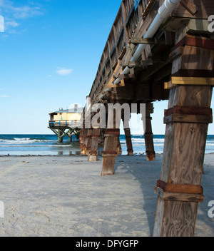 Legs of wooden pier in Daytona beach shores Florida Stock Photo