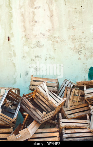 Wooden crates. Pile of old wooden crates against the wall. Stock Photo