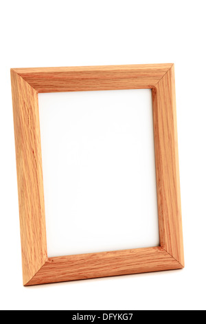 Empty wooden rectangular blank picture frame made from Oak wood close-up and isolated on a white background at an oblique angle. Stock Photo