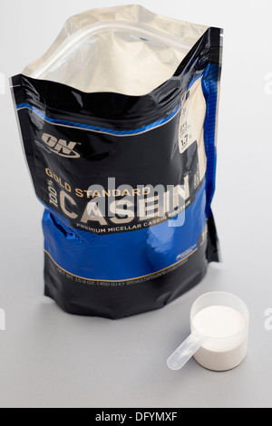 Resealable bag of ON brand Gold 100 percent Casein premium micellar casein protein with measuring scoop Stock Photo