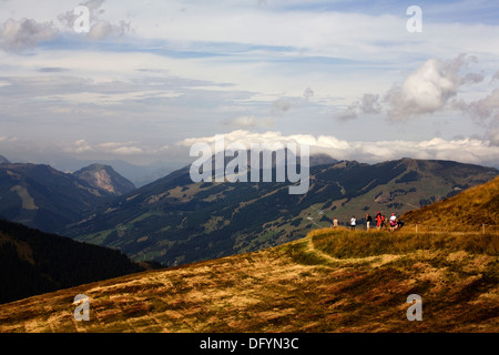 Walkers on footpath near Hochzeller-alm restaurant near the summit of The Schmittenhohe above Zell am See Salzburgerland Austria Stock Photo