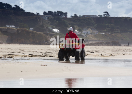 RNLI  Lifeguards on St Ouen's beach Jersey & red Quad Bike Channel Islands Stock Photo