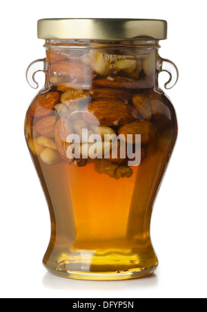Jar with honey and nuts isolated on white Stock Photo