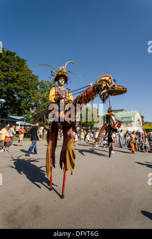 Fantasy creature on stilts, midway at Great New York State Fair, Syracuse. Stock Photo