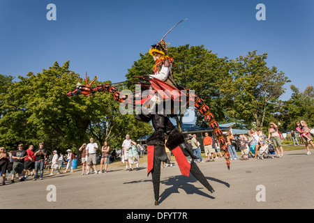 Fantasy creature on stilts, midway at Great New York State Fair, Syracuse. Stock Photo