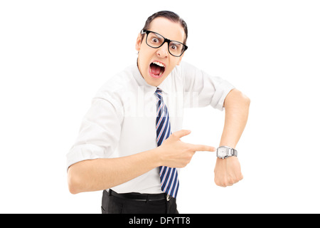 Angry man shouting and pointing on a wrist watch Stock Photo