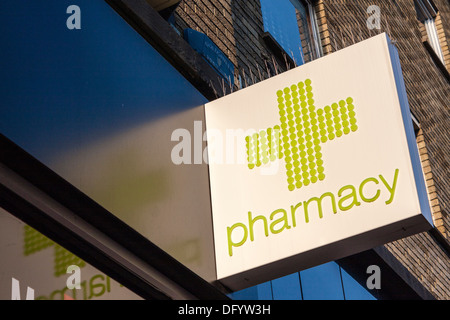 Green cross sign above high street Superdrug pharmacy Stock Photo