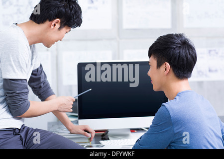 Young adults discussing in office Stock Photo