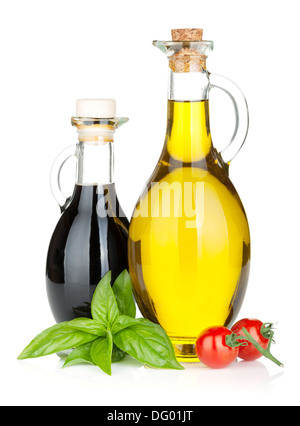 Olive oil, vinegar bottles with basil and tomatoes. Isolated on white background Stock Photo