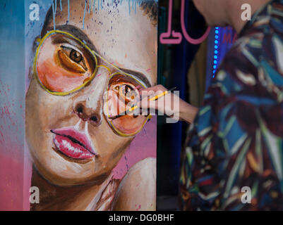 Artist Evan Barlow painting a face, at Vogue Fashion's Night Out, a one-night-only after-work shopping event moved to Manchester, from London, for the first time.  More than 150 city centre retailers, outdoor markets, bars and restaurants opened late into the night. The Heart of Manchester retail Business Improvement District (BID) and CityCo supported the event, to position Manchester as the UK’s leading retail destination outside London. Stock Photo