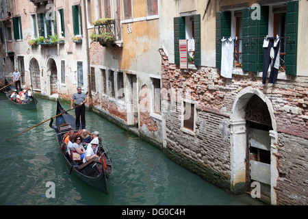 High-angle shot on gondolas from the vantage point of a Venetian bridge (Venice - Italy). Vue sur des gondoles depuis un pont Stock Photo