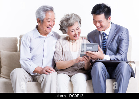Senior couple with financial advisor Stock Photo