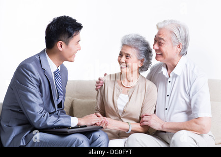 Senior couple chatting with financial advisor Stock Photo