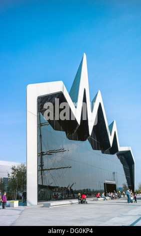 An imposing front view of the Riverside Museum Glasgow with a reflection of the adjacent moored tall ship the Glenlee Stock Photo