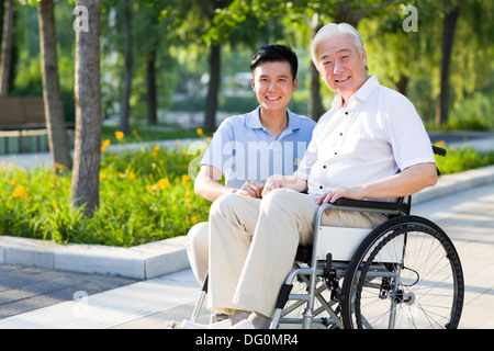 Wheelchair bound man with nursing assistant Stock Photo