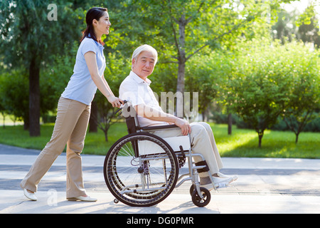 Wheelchair bound man with nursing assistant Stock Photo