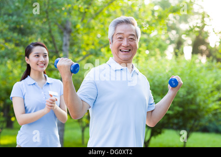 Senior man exercising with dumbbell in nursing home Stock Photo