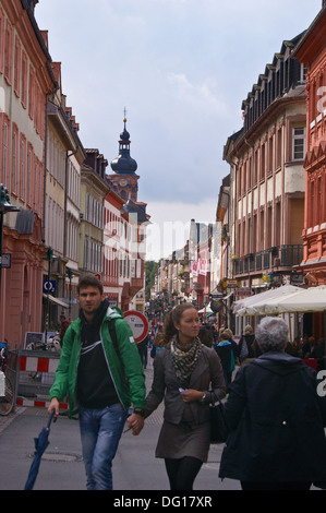 A young couple holding hands in Hauptstrasse, Heidelberg, Baden-Wurttemberg, Germany Stock Photo