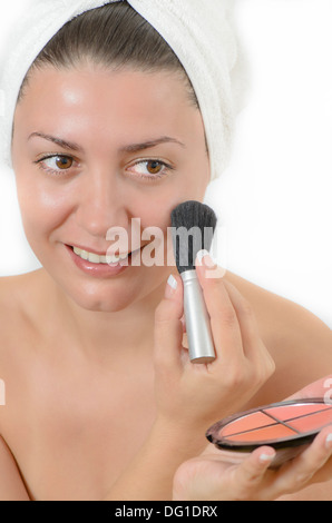 Young woman applying make up with a brush Stock Photo