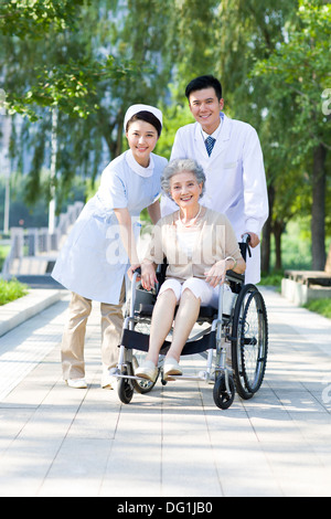 Doctor, nurse and wheelchair bound patient Stock Photo