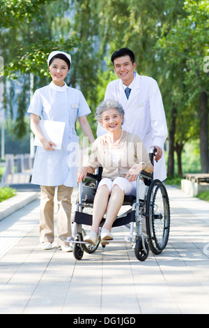 Doctor, nurse and wheelchair bound patient Stock Photo